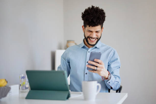 istock Happy and excited man looking at phone for game score 1403098590