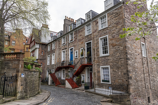 Cosy stone building with nice colorful stairs to a front doors in Edinburgh, Scotland.