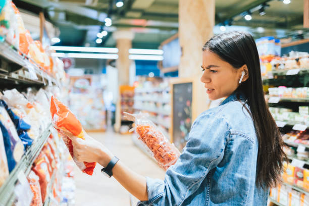 dissatisfied young woman wearing casual outfit and earphones - food staple audio imagens e fotografias de stock