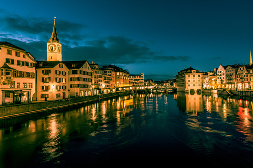 Fraumunster Church Pointing Over Buildings At Night In Zurich, Switzerland