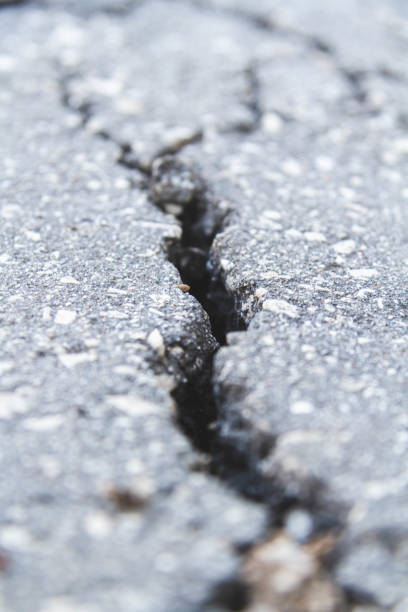 istock Stone wall with deep cracks. Break in the ground. Drought and consequences. 1403100408