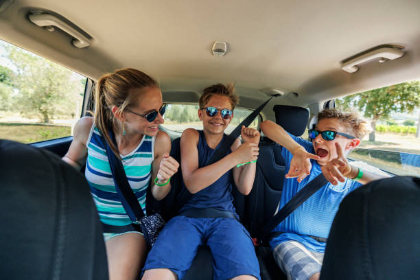 istock Three kids travelling by car 1403101440