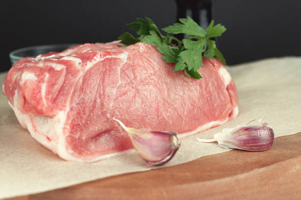 istock Fillet steak beef meat for grilling with seasoning and garlic on light rustic board. 1403102453