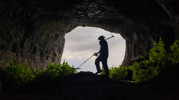 istock treasure hunter with metal detector searching inside the cave in the historical texture 1403102637