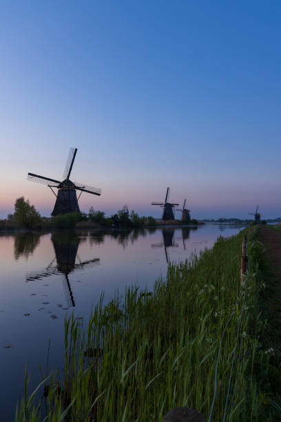 istock Traditional Dutch windmills with a colourful sky just before sunrise in Kinderdijk, The Netherlands 1403103307