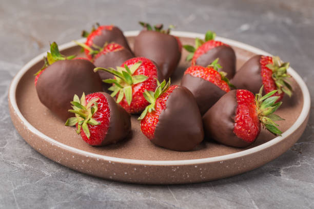 istock Dark chocolate covered strawberries on ceramic plate. Gourmet food. 1403103643