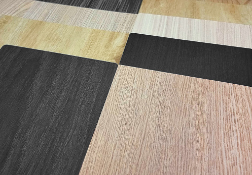 various types and textures of interior wooden material including veneer, laminated, vinyl flooring samples. multi texture of wood use as background. Production of wooden materials (focus at center).