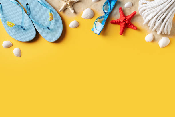 istock Summer holidays flat lay with shells, starfish and accessories on yellow background 1403108403