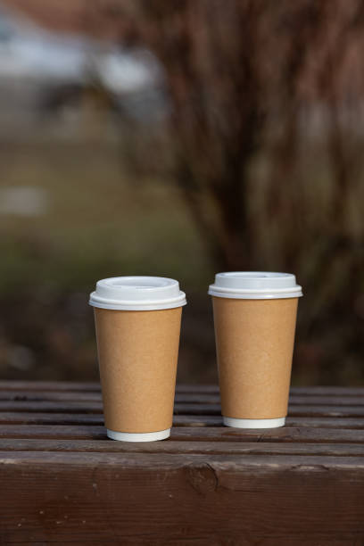 istock Two paper craft cups of coffee on the bench 1403108584