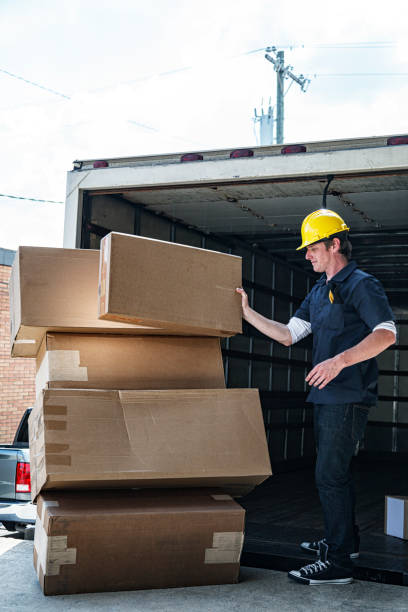 istock Delivery Worker Stacking Cardboard Cartons on Hand Truck 1403109510