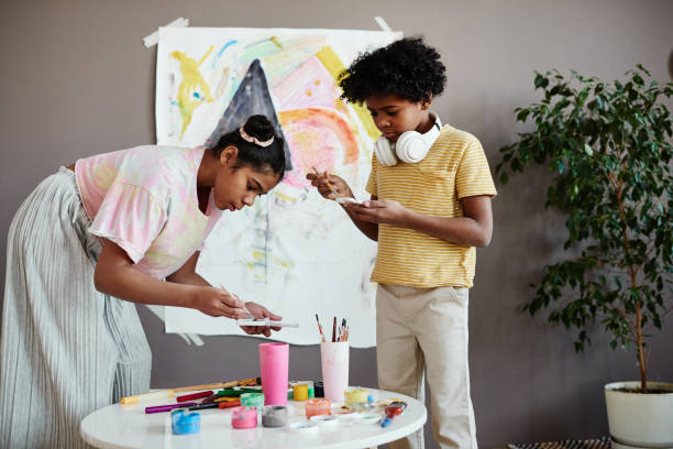 istock Children painting together with paints 1403111574
