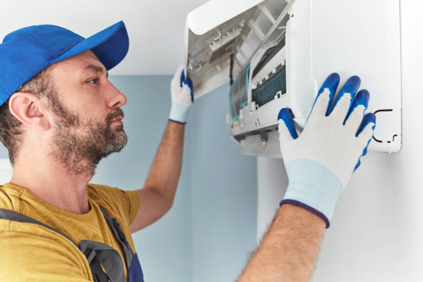 istock Repairman cleaning and fixing indoors AC unit. 1403111847