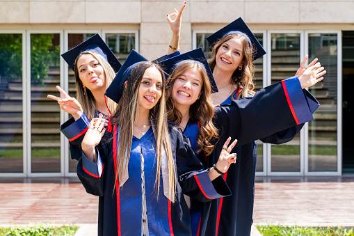 female friends group takes joyful photo after graduation