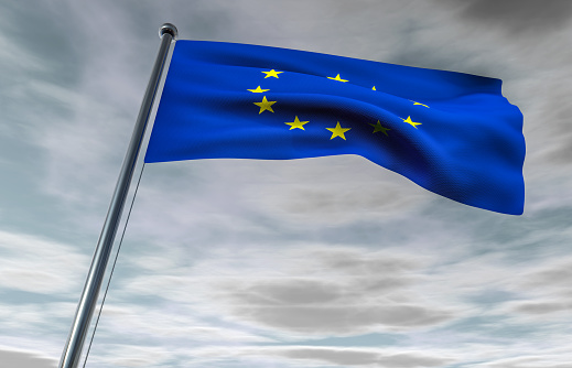 European Union Flag on a Cloudy Sky