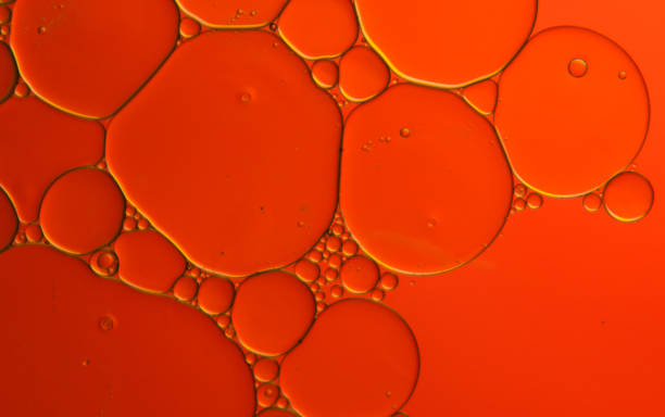 istock Red oil bubbles on a water surface as an abstract background 1403116615
