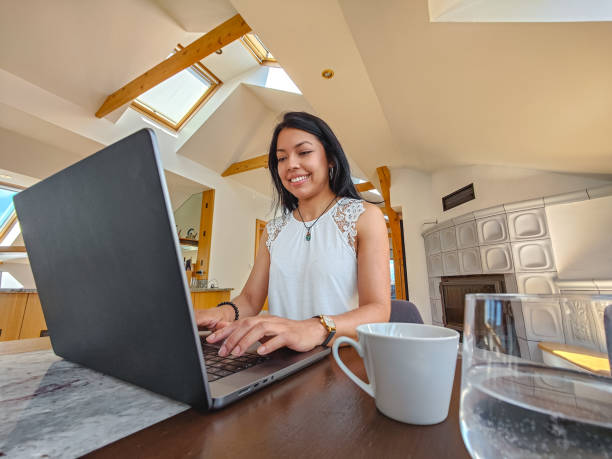 istock Hispanic Business Woman Using Laptop At Home 1403117432