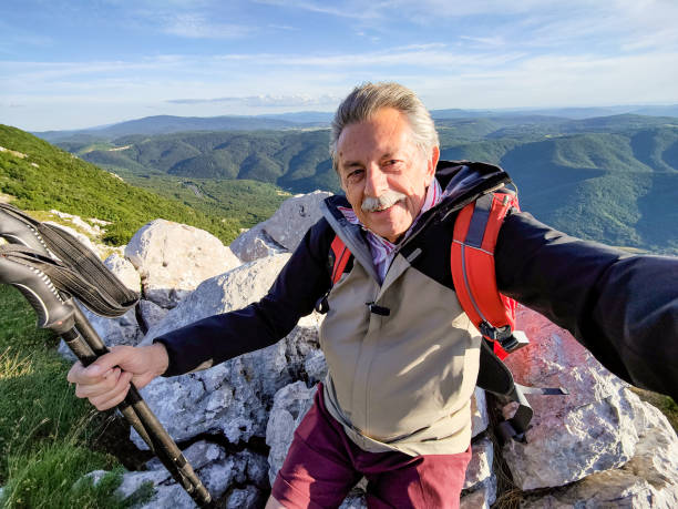 istock Senior Man Taking a Selfie in The Mountains 1403117444
