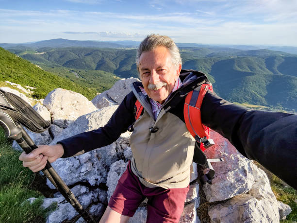 Senior Man Taking a Selfie in The Mountains