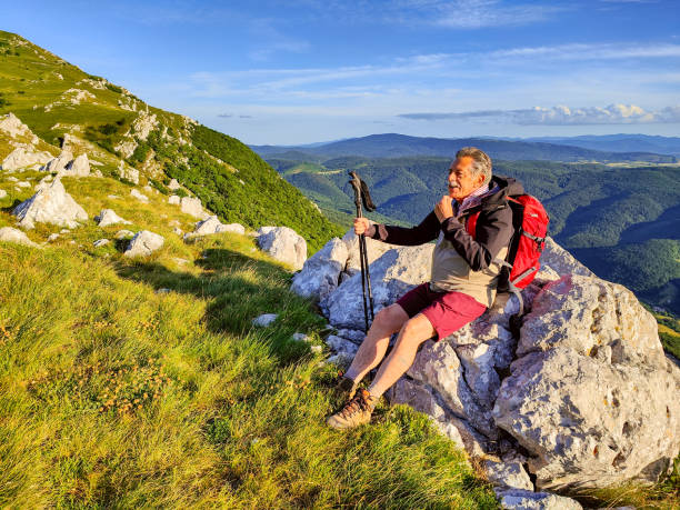 istock Senior Male Hiker Sitting Down And Relaxing 1403117506
