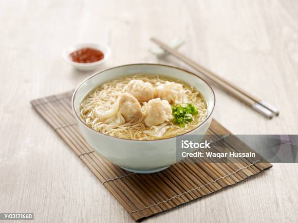 Signature Canton Jumbo Prawn Wanton Noodle With Chopsticks Served In A Bowl Isolated On Mat Side View On Grey Background Stock Photo - Download Image Now