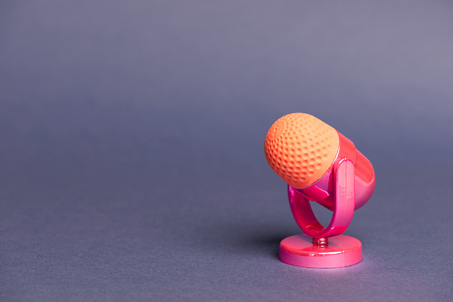 Pink microphone on blue background.