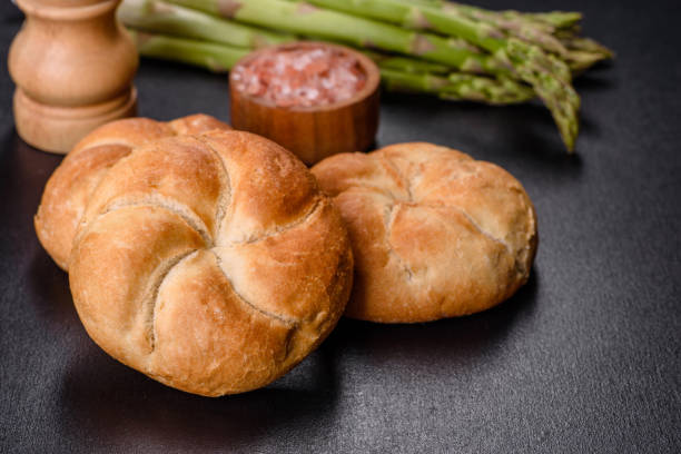 istock Crusty round bread rolls, known as Kaiser or Vienna rolls on a cutting board 1403123468