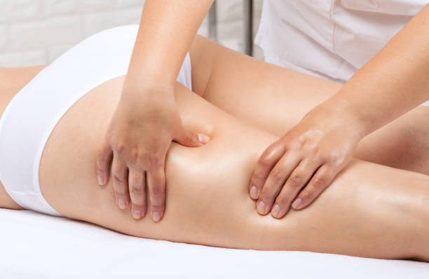 Masseur makes anti-cellulite massageon the legs, thighs, hips and buttocks in the spa. Overweight treatment, body sculpting.Cosmetology and massage concept. stock photo
