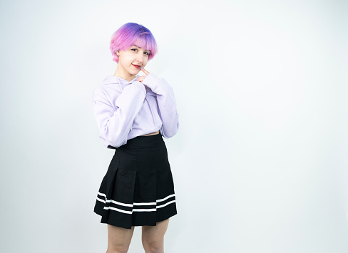 Portrait of young woman with pink short hair studio shoot isolated on white background