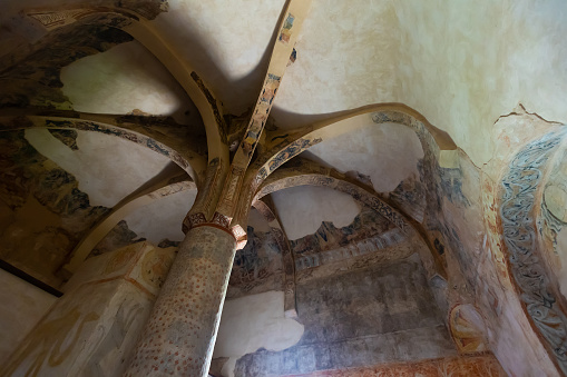 Remains of antique Romanesque frescoes on walls, ceiling and supporting pillar in ancient Church of San Baudelio de Berlanga in Spanish province of Soria