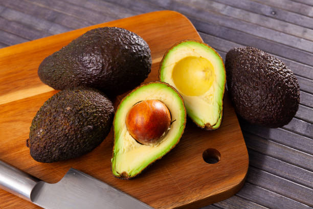 istock Raw organic avocado on wooden table 1403128696