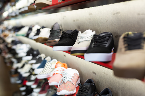 Variety of modern male sneakers in streetwear showroom