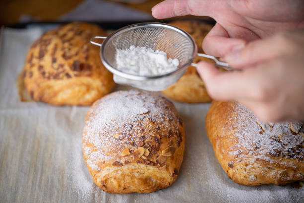istock spreading powdered sugar on almond coissants 1403128804