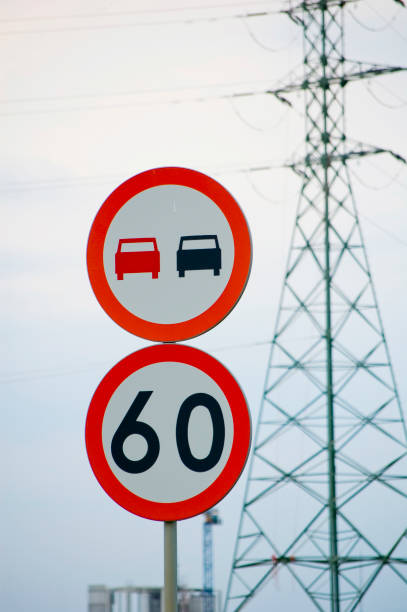 istock No overtaking and speed limit signs against industrial sky. 1403129929