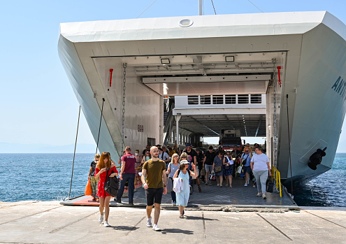 Aegina, Greece, - May 2022: People getting off a ferry on the island of Aegina after arriving from Athens.