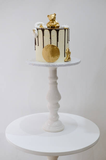 istock chocolate cake with a gold bear and stars on a white plate 1403138142