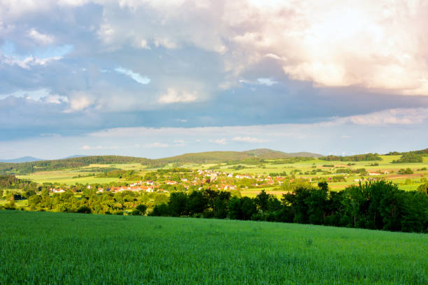 panoramic view of fields and meadow and small village