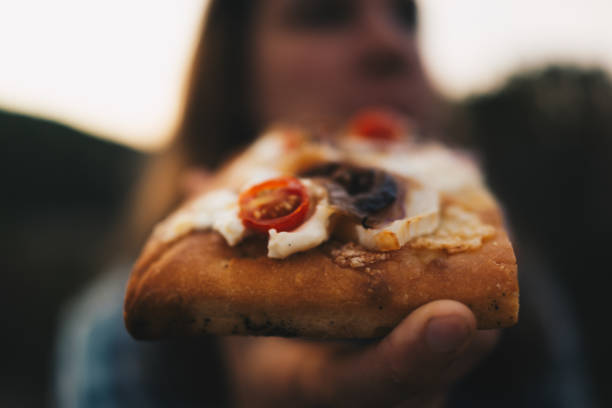 istock Young woman eats fresh bread with cheese and tomatoes 1403139402