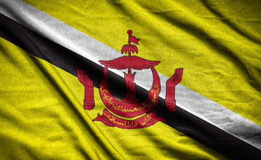 Realistic flag of  brunei darussalam on the wavy surface of fabric
