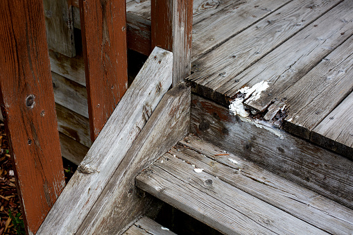 closeup of old wooden stairs badly repaired
