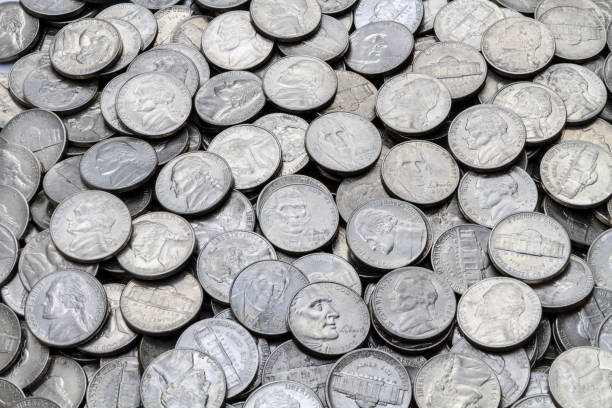 Pile Of Various Used Circulated Modern USA Jefferson Nickels A close up shot of a pile of various used modern clad (non-silver) USA Jefferson five cent nickels. clad stock pictures, royalty-free photos & images