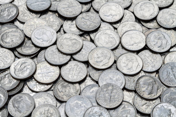 Pile Of Various Used Circulated Modern USA Roosevelt Dimes A close up shot of a pile of various used modern clad (non-silver) USA Roosevelt Dimes. ten cents stock pictures, royalty-free photos & images