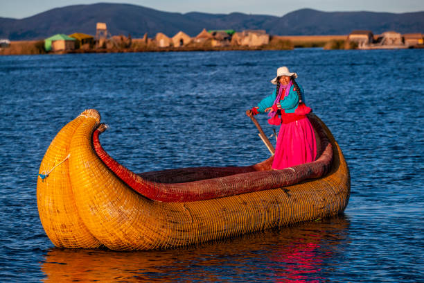 istock Peruvian woman sailing between Uros floating islands, Lake Tititcaca 1403141769