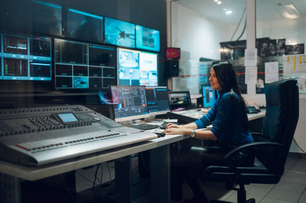 istock Middle aged woman using equipment in control room on a tv station 1403143668