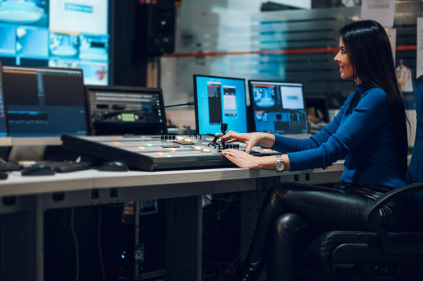 istock Middle aged woman using equipment in control room on a tv station 1403143673