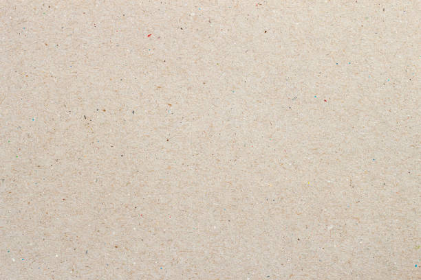 istock Light paper texture cardboard background close-up. Grunge paper surface texture with small inclusions of cellulose 1403146508