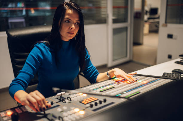 istock Middle aged woman using equipment in control room on a tv station 1403149039