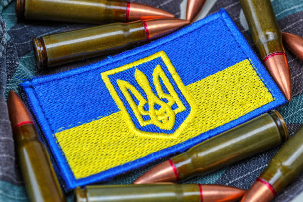 Fabric curved flag of Ukraine, UA. Blue and yellow colors.Ukraine patch on army uniform.Stop war.Patriotism.Concept of Ukraine.Democracy and politics. Close up shot, background stock photo