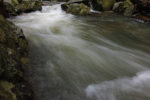 Small waterfall in a torrent, shallow depth of field
