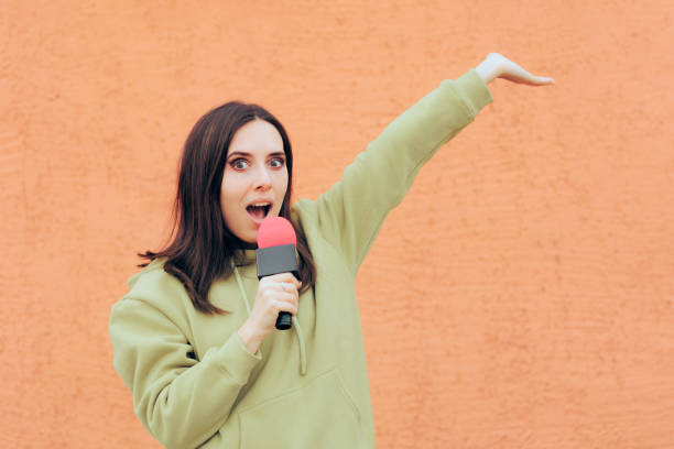 istock Happy Woman Holding the Microphone Making an Announcement 1403165538