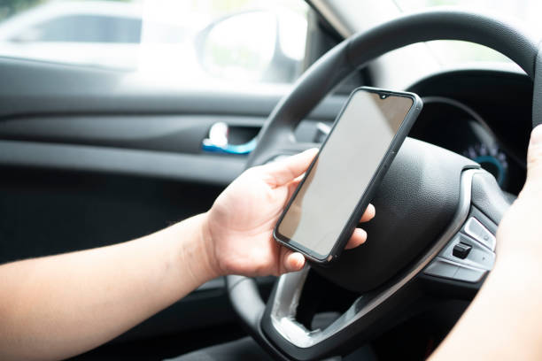 istock The driver looks at the mobile navigation in the car 1403167219